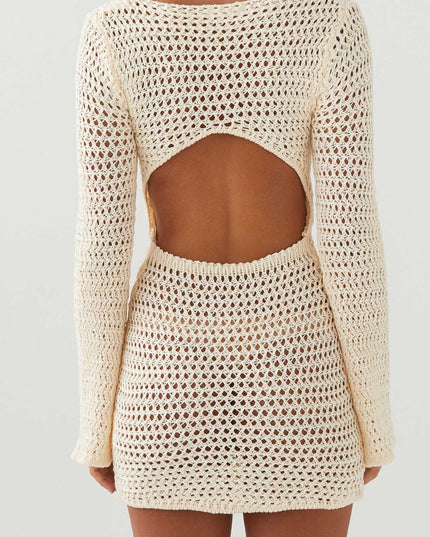 Back view of the cream long sleeve crochet mini dress, clearly showing the open back cut-out design.