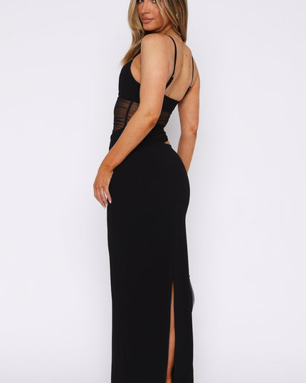 Back view of a black mesh cut-out V-neck maxi dress, highlighting the back slit and thin straps.
