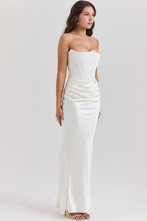 Full body view of a white off-shoulder bustier draped maxi dress with a sweetheart neckline and ruched detailing.