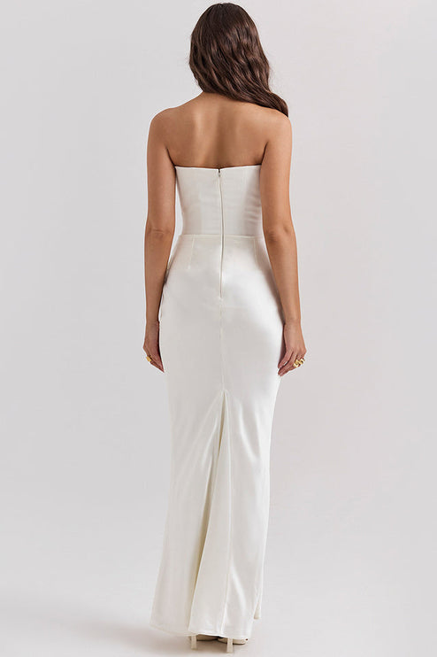Back view of a white off-shoulder bustier maxi dress, highlighting the straight back and subtle train.