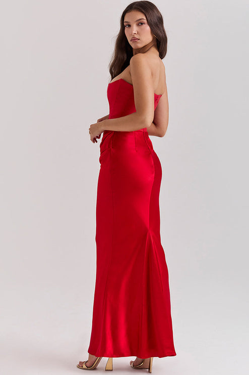 Side view of a red off-shoulder bustier maxi dress, showing the smooth fabric and subtle back detail.