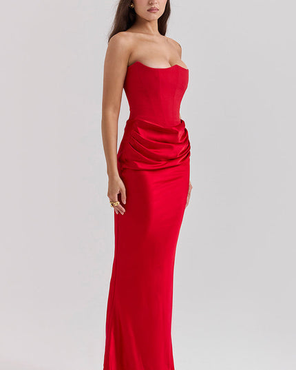 Three-quarter view of a red off-shoulder bustier draped maxi dress, for an evening or wedding event.