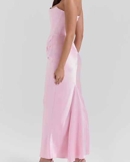Profile view of the pink off-shoulder bustier maxi dress, emphasizing the elegant drape and form-fitting style.