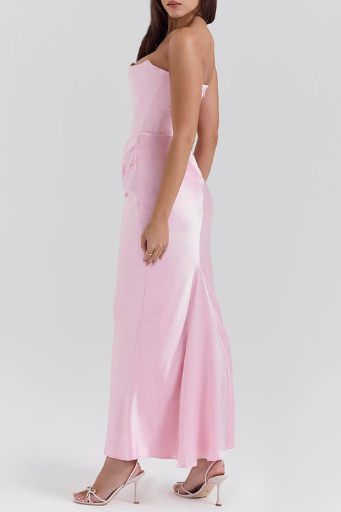 Profile view of the pink off-shoulder bustier maxi dress, emphasizing the elegant drape and form-fitting style.