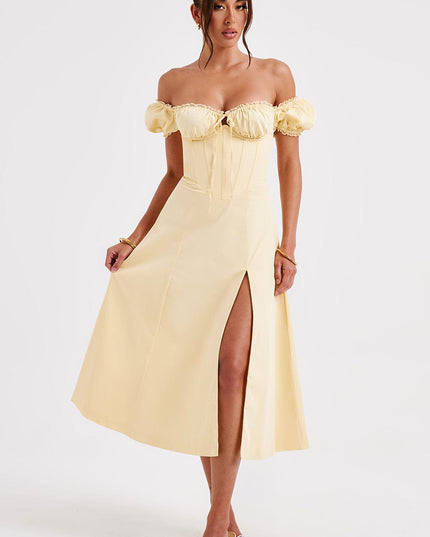 Full view of a light yellow off-shoulder puff sleeve corset midi dress with a front split.