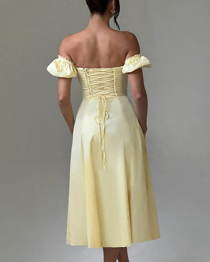 Studio shot, back view of a light yellow off-shoulder puff sleeve midi dress, showing the corset lace-up detail.