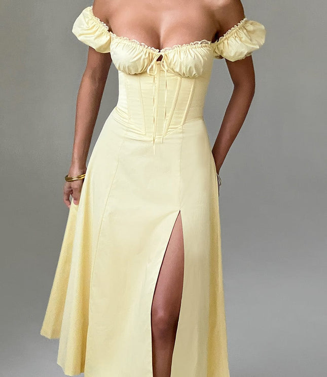 Studio shot, front view of a light yellow off-shoulder puff sleeve corset midi dress with a thigh-high split.