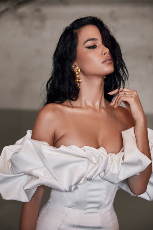 Close-up of the off-shoulder ruffle satin mini dress in white, focusing on the intricate ruffles and luxurious fabric.