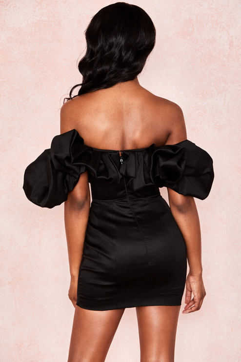 Back view of the black off-shoulder ruffle satin mini dress, showing the zipper detail and fitted skirt.