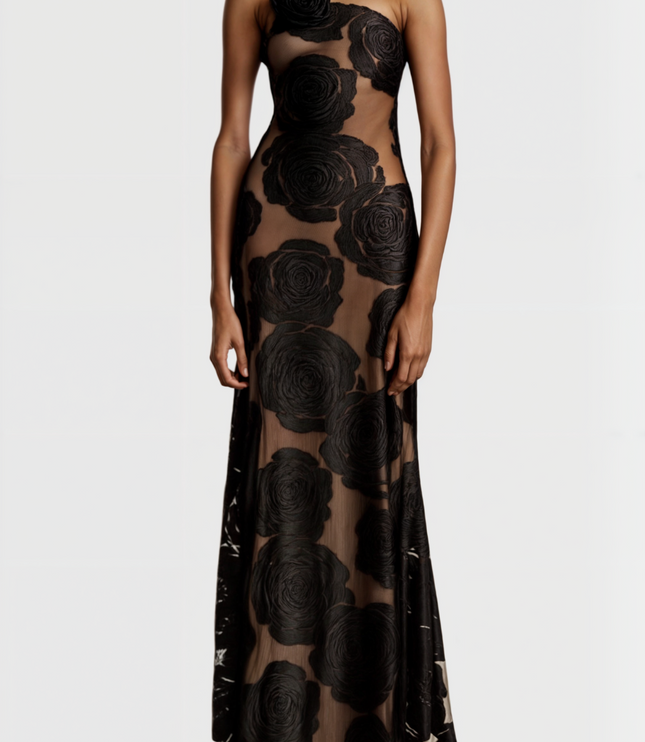 Front detail of the black rose floral maxi dress, showing the intricate one-shoulder design and sheer fabric.
