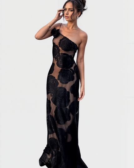 Women's one-shoulder black rose floral maxi dress, fitted silhouette with sheer details, front view.