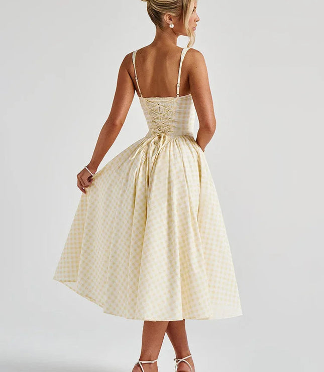 Back view of women's light yellow gingham midi dress, showing lace-up corset detail and full skirt