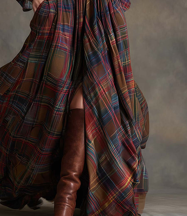 Lower half of a women's flowing multi-color plaid maxi dress, a high slit and brown leather boots.