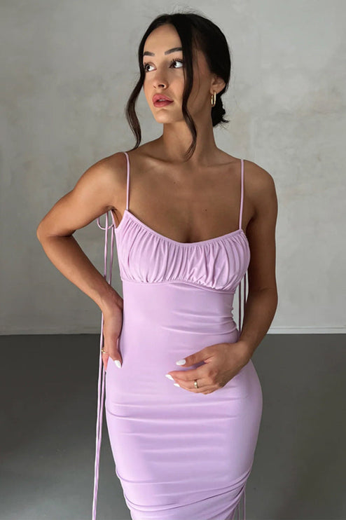 Close-up front view of a light purple pleated plunge neck maxi dress, highlighting the ruched top and fabric texture