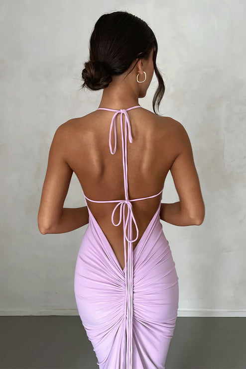 Back view of a light purple pleated plunge neck backless maxi dress with delicate tie straps and ruched detailing.