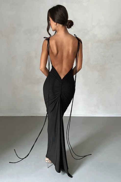 Back view of a women's black pleated plunge neck backless maxi dress with long tie details