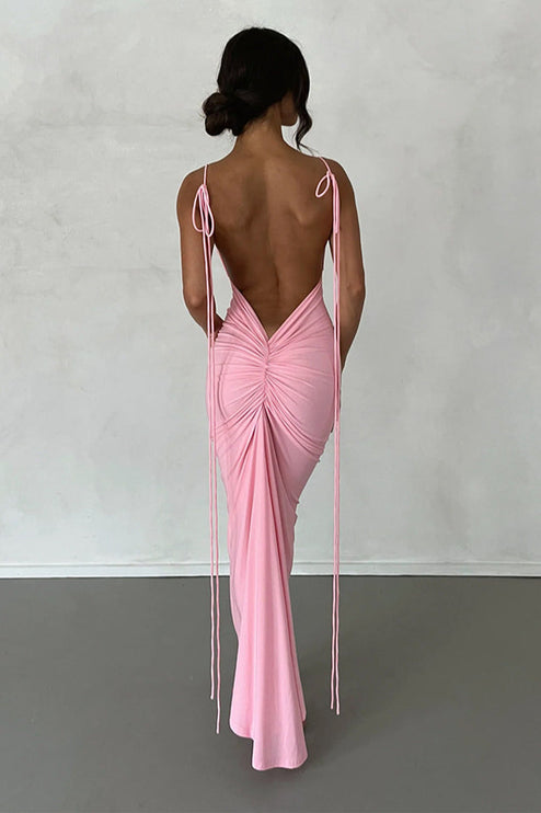 Back view of a women's pink pleated plunge neck backless maxi dress with adjustable tie straps