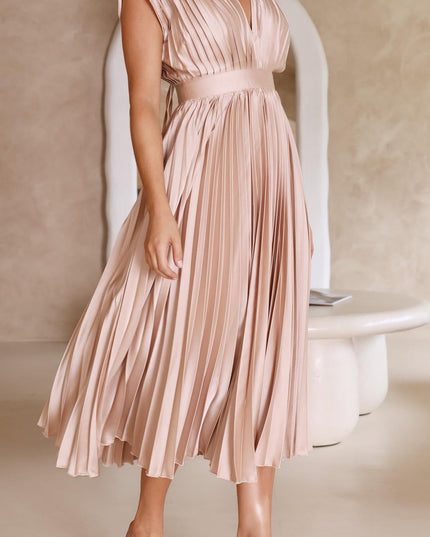 Full-length view of a women's pleated v-neck midi dress in a shimmering light champagne color, with a cinched waist and flowing skirt.