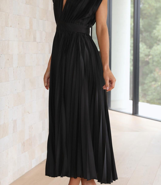 Side profile of the black pleated v-neck midi dress, highlighting the structured bodice and the elegant drape of the pleated skirt.