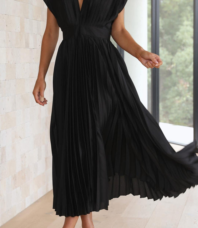 Action shot of the black pleated v-neck midi dress, with the skirt twirling to emphasize its voluminous pleats and flow.