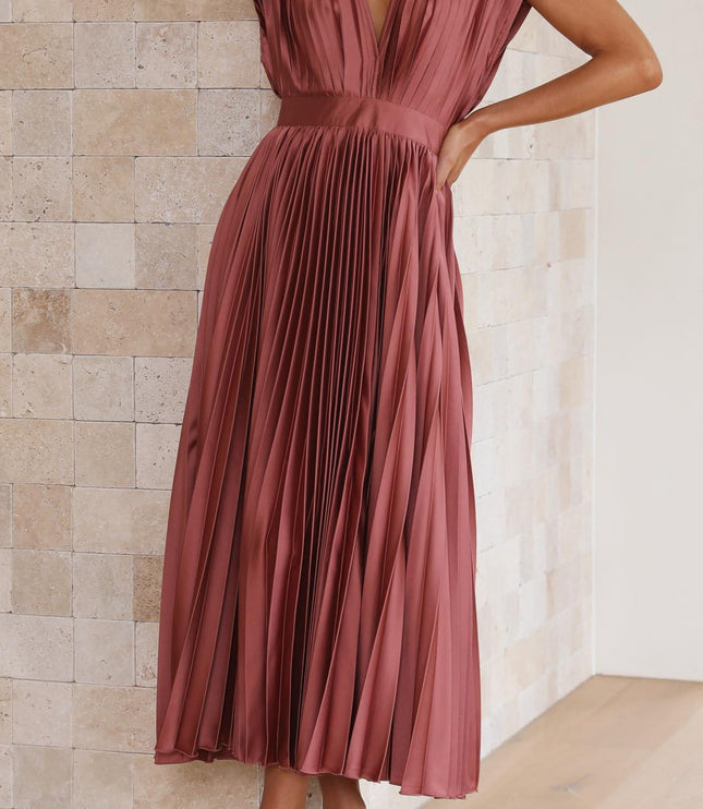 Side profile of a women's rose pleated v-neck midi dress, showcasing the flowing skirt and fitted bodice.