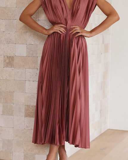 Front view of a pleated v-neck midi dress in a rich rose color, with a cinched waist and wide shoulder straps.