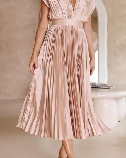 Women's light pink pleated v-neck midi dress, with the skirt gently lifted to show the full pleat detail and movement.