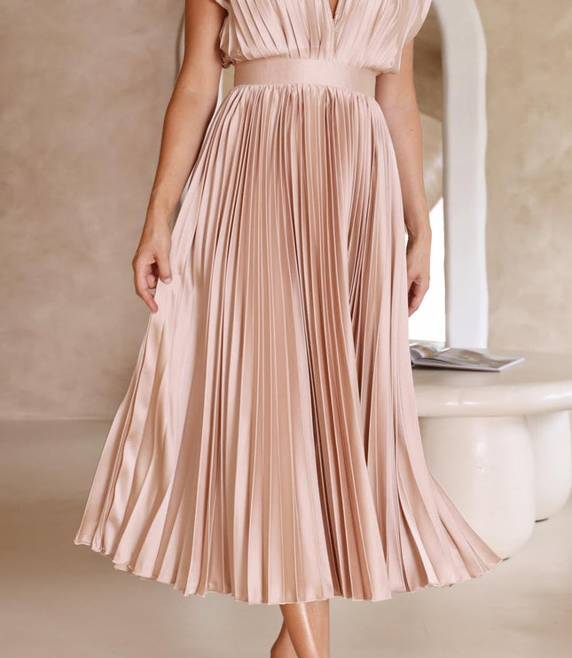 Women's light pink pleated v-neck midi dress, with the skirt gently lifted to show the full pleat detail and movement.
