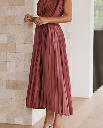 Front view of a women's rose pleated v-neck midi dress, with hands clasped, showing the elegant drape of the fabric.