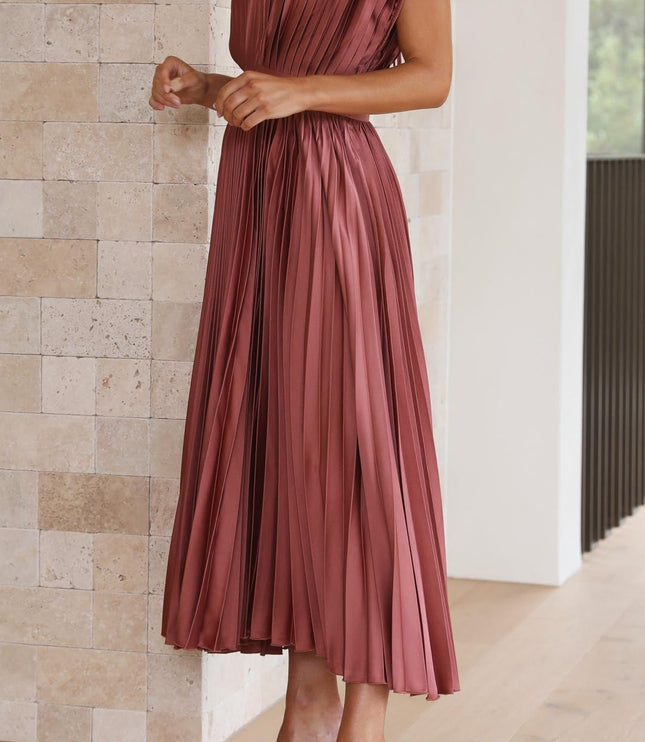 Front view of a women's rose pleated v-neck midi dress, with hands clasped, showing the elegant drape of the fabric.