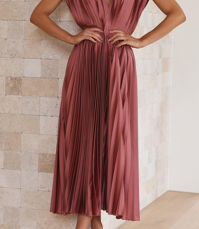 Front view of a pleated v-neck midi dress in a rich rose color, with a cinched waist and wide shoulder straps.