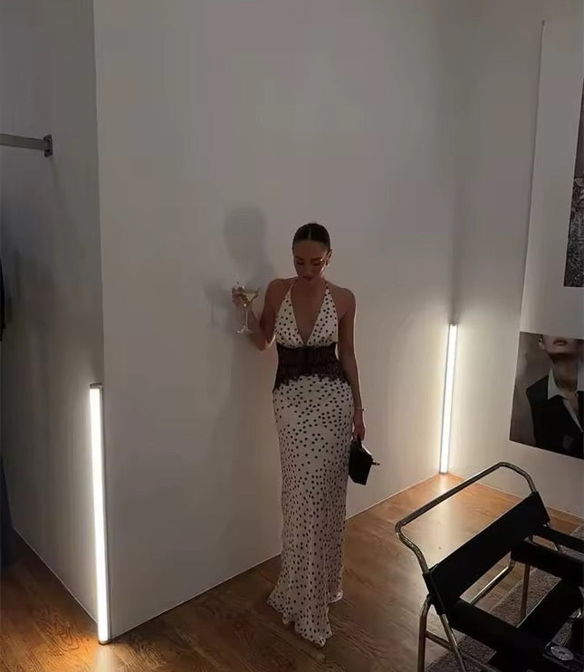 Full length shot of the women's polka dot halter neck lace maxi dress, featuring the deep V-neck and black lace waist.