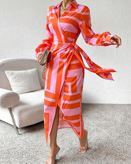 Women's long sleeve V-neck midi dress in a striking orange and pink geometric block print, with a high slit and tie waist.