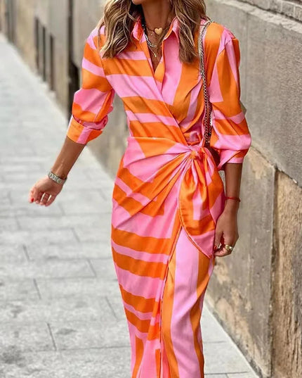 Women's long sleeve V-neck midi dress in a vibrant orange and pink striped print, shown with a knotted waist.