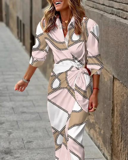 Women's long sleeve V-neck midi dress featuring a light pink, white, and beige chain-link pattern, tied at the waist.