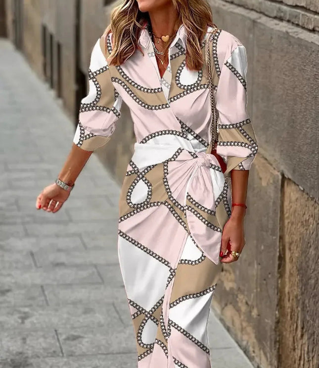 Women's long sleeve V-neck midi dress featuring a light pink, white, and beige chain-link pattern, tied at the waist.