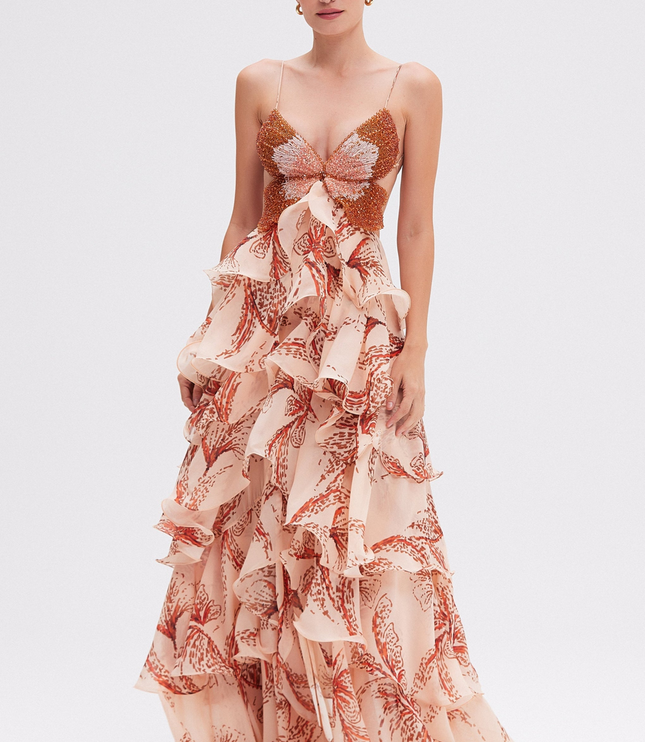 Full-length women's prom maxi dress with beaded butterfly bodice and tiered ruffles in a light peach print.