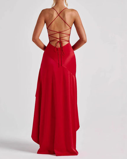 Back view of a red high low maxi dress featuring a lace-up back design and flowing skirt.