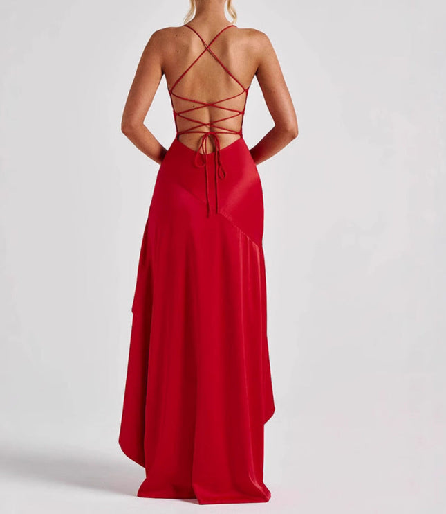 Back view of a red high low maxi dress featuring a lace-up back design and flowing skirt.
