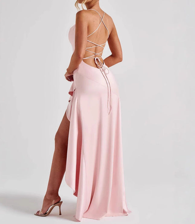Back view of a light pink high low maxi dress with a criss-cross lace-up back and ruffled detail.