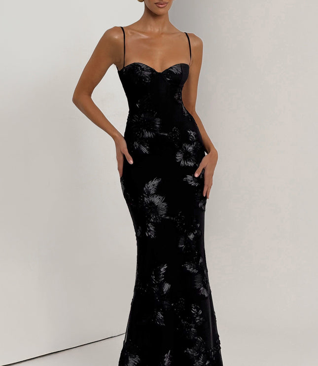 Full-length front view of the black floral lace-up corset maxi dress, highlighting the shimmering floral appliques.