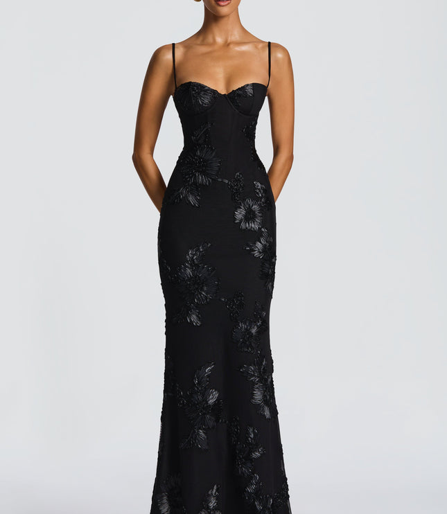 Full-length front view of a black floral maxi dress with thin straps and elegant floral patterns, ideal for formal occasions.