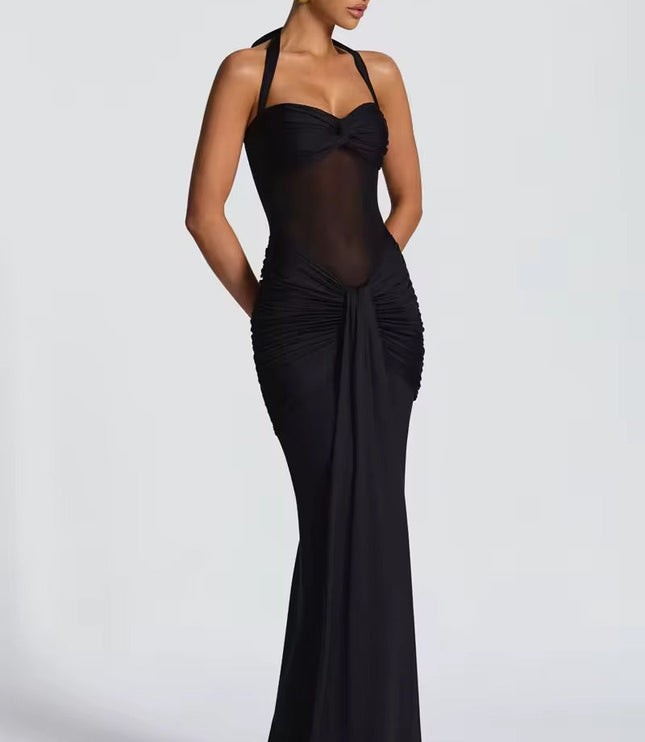 Side view of a women's black halter neck ruched mesh maxi dress, showcasing the fitted silhouette.