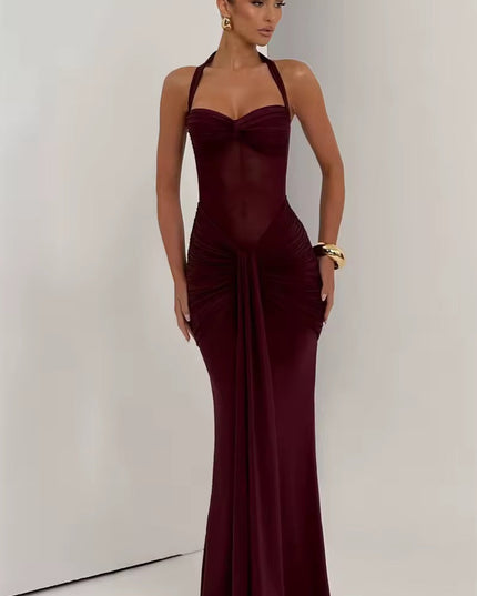Full-length view of a women's prom halter neck ruched mesh maxi dress in a deep burgundy color, with a sweetheart neckline and knotted front detail.