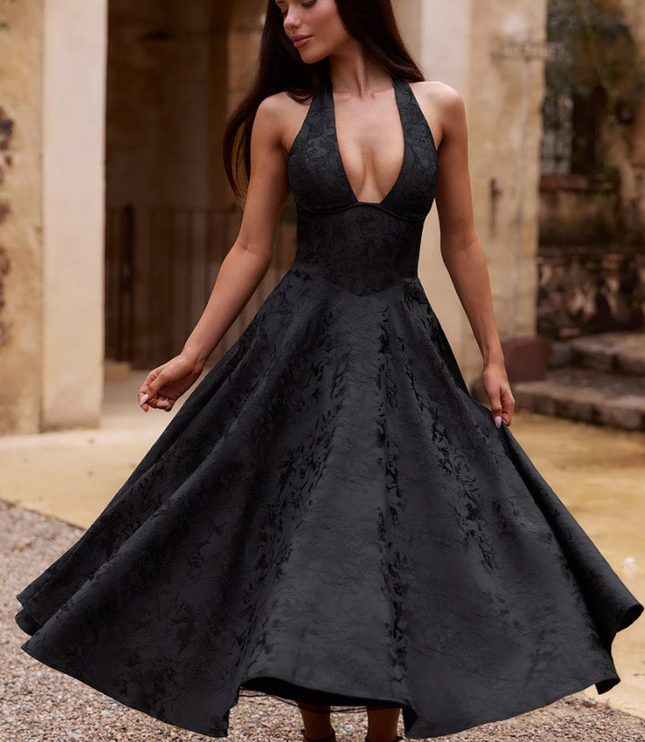 Black jacquard midi dress with a halter v-neck, full skirt, and subtle floral pattern, for prom or formal events.