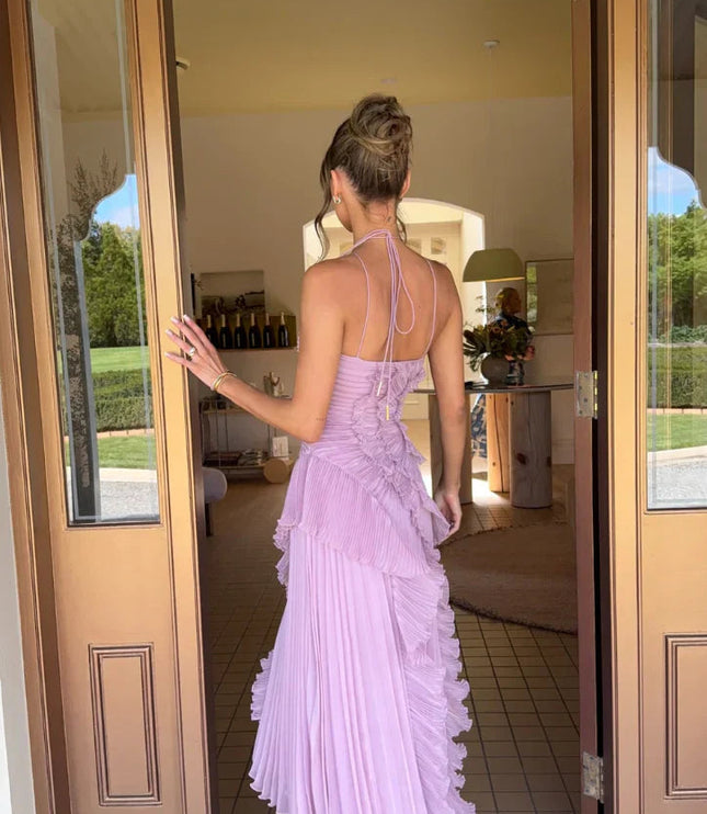 Back view of the women's lavender one-shoulder midi dress, showcasing the delicate spaghetti straps and pleated skirt.