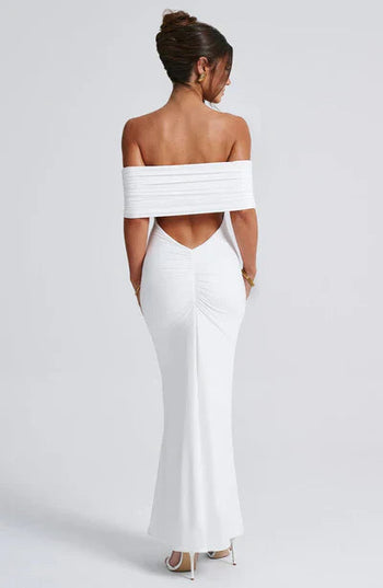 Back view of a white off-shoulder maxi dress, with a stylish ruched back and a graceful V-neckline.