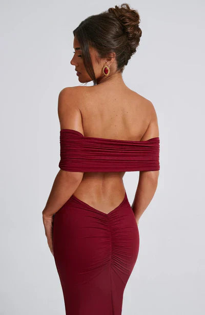 Detailed back view of the burgundy off-shoulder maxi dress, focusing on the ruched back and V-cut design.