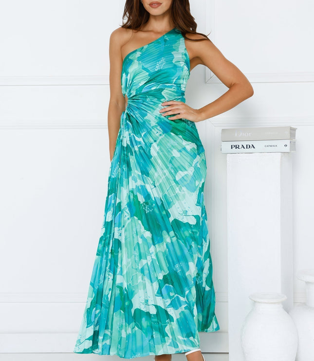 Full length view of a women's blue and green floral one shoulder maxi dress with a side cutout and pleated skirt.