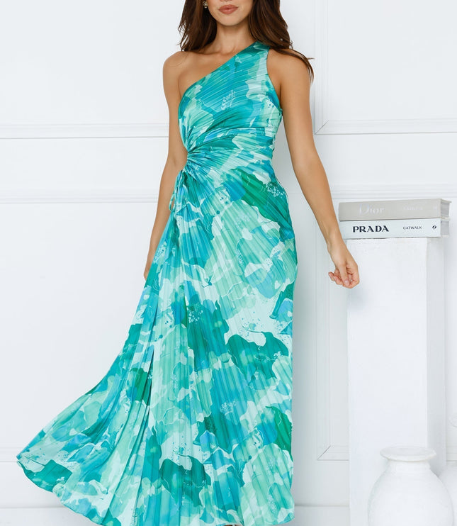 Women's elegant one shoulder maxi dress in a teal and aqua floral print, featuring a pleated skirt and waist cutout.